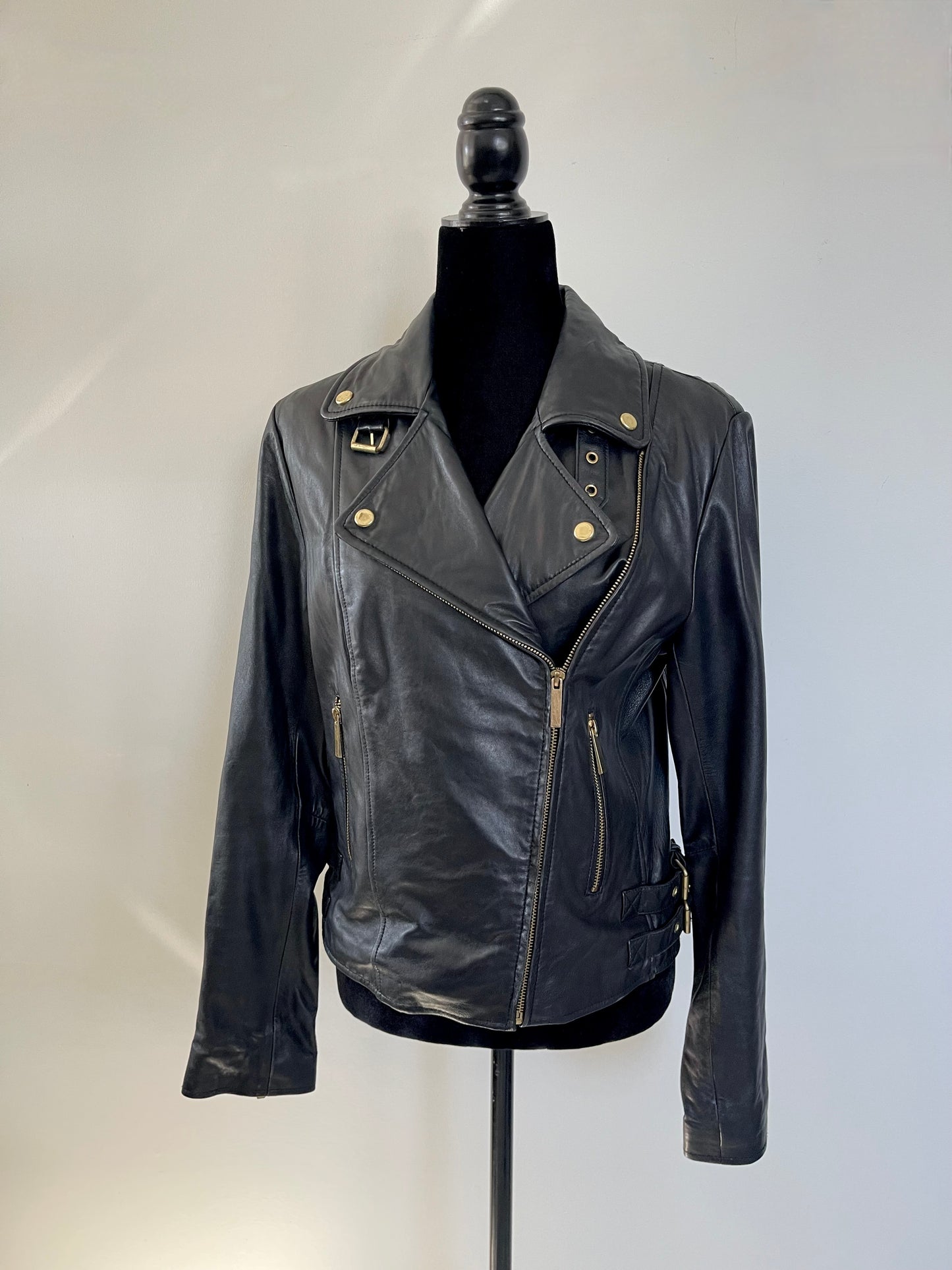 Black leather Vintage Y2K Victoria's Secret Leather Motorcycle Jacket on a mannequin against a white background