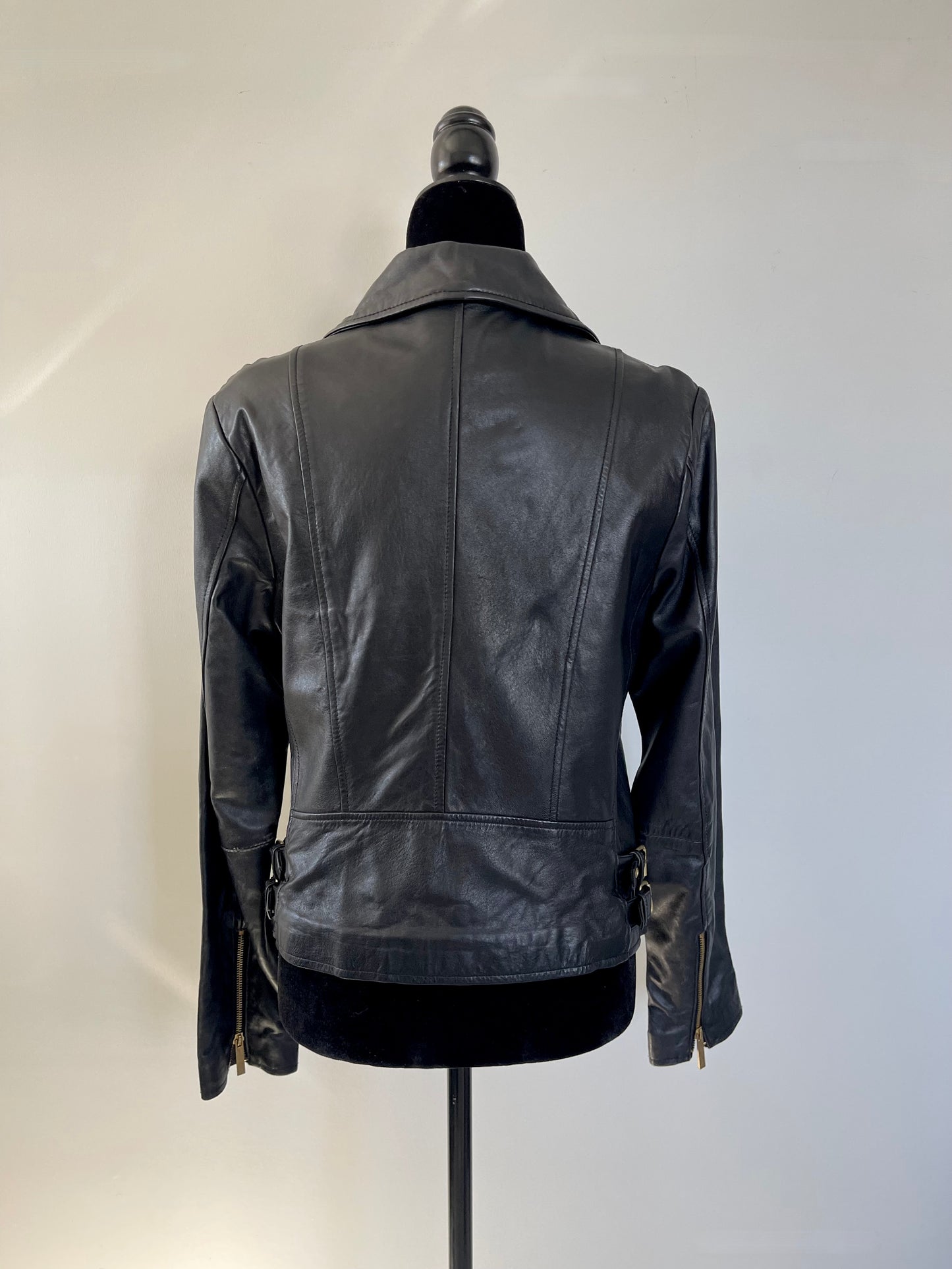 Black Vintage Y2K Victoria's Secret Leather Motorcycle Jacket on a mannequin against a white background